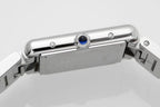 Cartier watch case top view with crown and blue gem detail on stainless steel