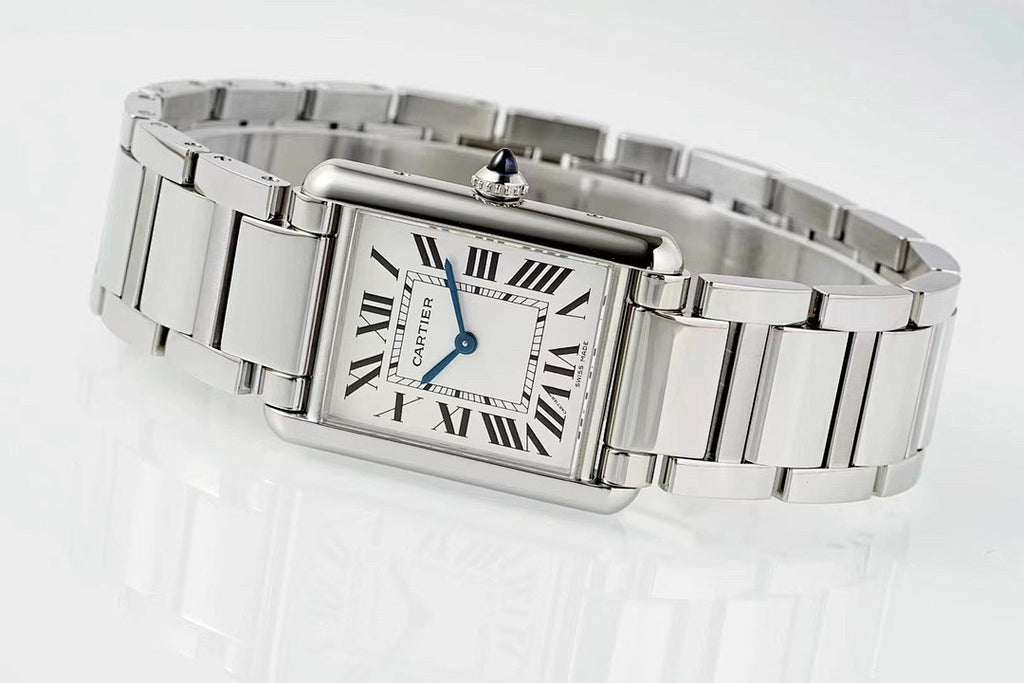 Cartier watch on wrist with rectangular Roman numeral dial and stainless steel band