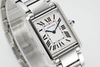 Cartier watch angled close-up showing Roman numeral dial and blue seconds hand