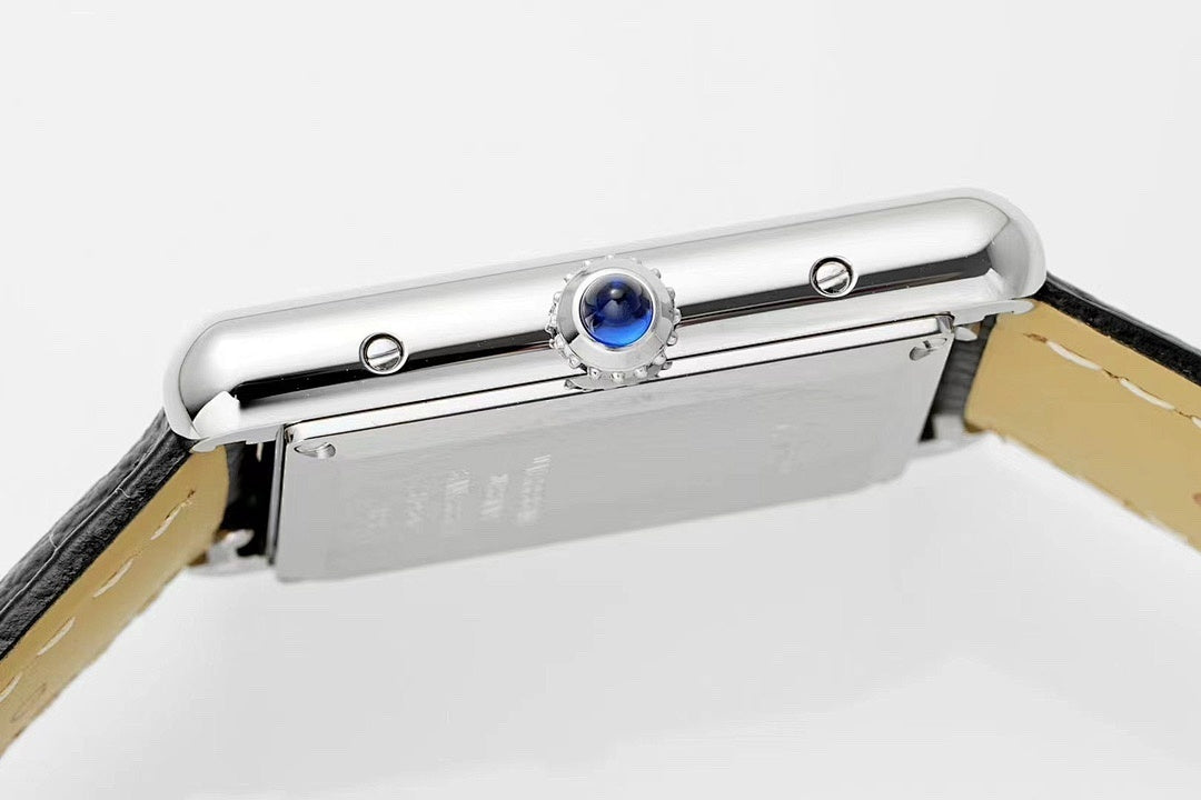Cartier wristwatch top view showing blue crown setting on a silver rectangular case
