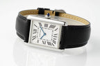 Cartier wristwatch side view with silver buckle, black leather strap, Roman numeral dial