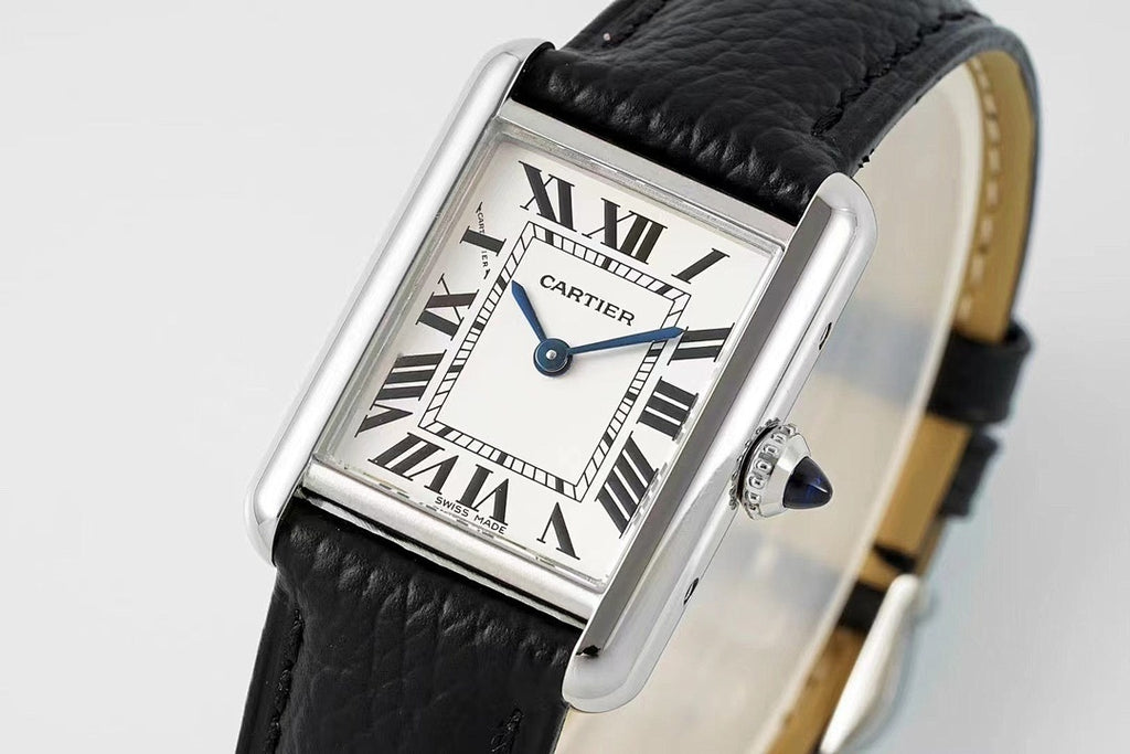 Cartier wristwatch close-up with black leather strap and Roman numeral dial, blue hands
