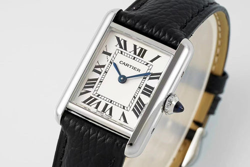 Cartier wristwatch close-up with black leather strap and Roman numeral dial, blue hands