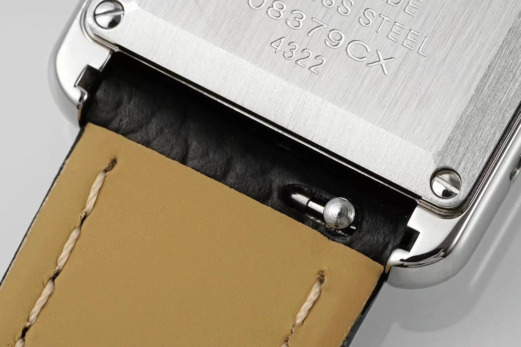Cartier watch case back with engraved steel panel and black leather strap edge