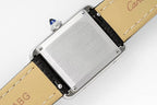 Cartier watch side view with engraved steel backplate and black leather strap, buckle end