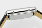 Cartier watch top view with silver case and black leather strap