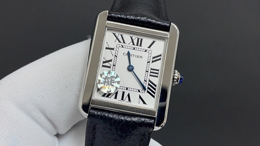 Cartier watch with silver case, black leather strap, Roman numeral dial with blue accents
