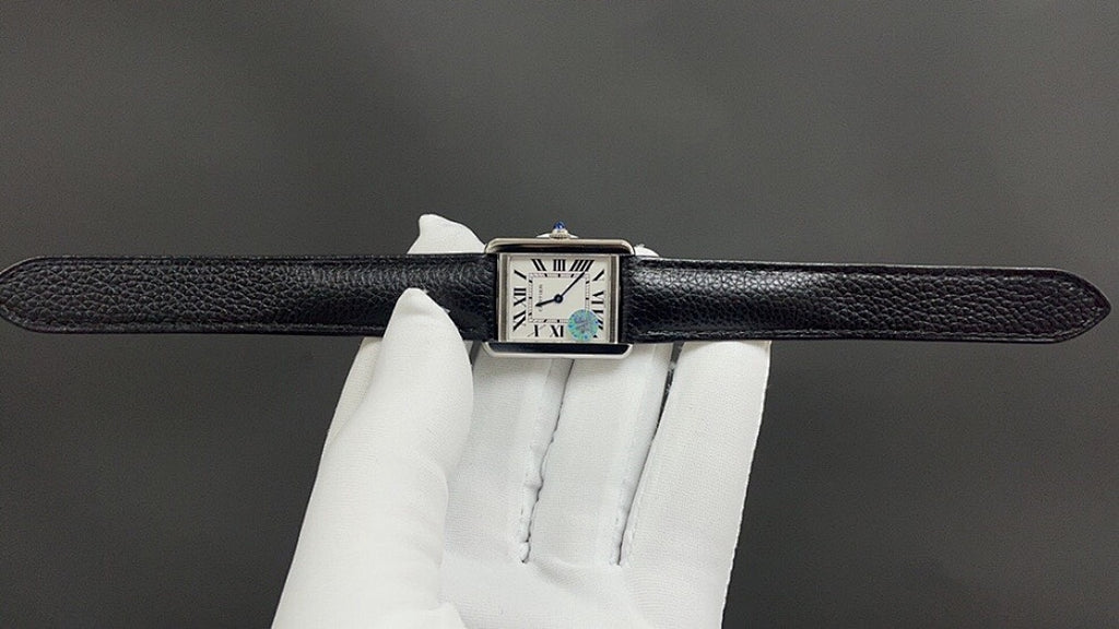 Cartier watch top view with black leather strap and Roman numeral dial