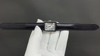 Cartier watch top view with black leather strap and Roman numeral dial