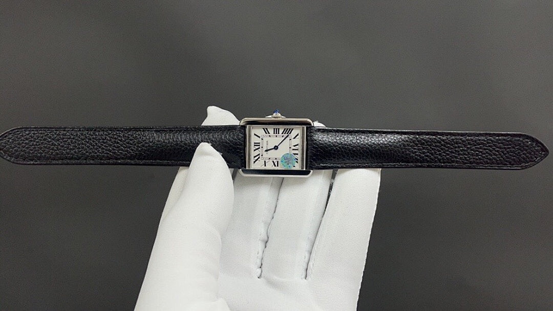 Cartier watch top view with black leather strap and Roman numeral dial