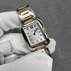 Cartier two-tone square wristwatch with silver dial, Roman numeral XII, and dark hands