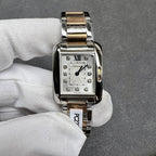 Cartier two-tone square wristwatch with silver dial, Roman numeral XII, and gem markers
