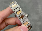Cartier watch side view showing silver links with gold accents along the bracelet