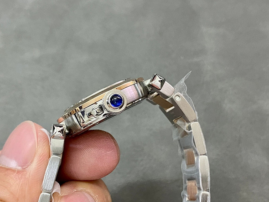 Cartier watch wristwatch top view with polished silver case and blue bezel detail