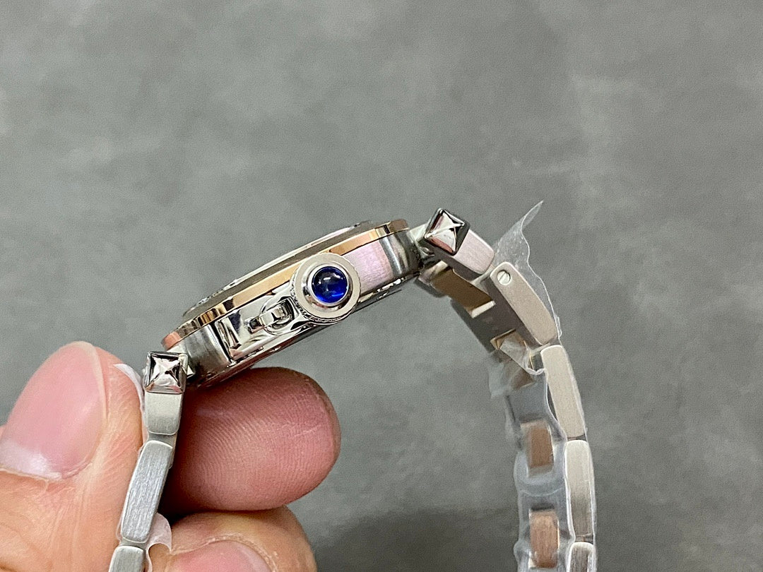 Cartier watch wristwatch top view with polished silver case and blue bezel detail
