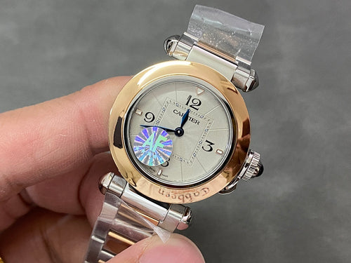 Cartier watch with gold bezel, silver bracelet, and white dial featuring a blue/purple motif