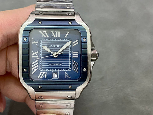 Cartier steel watch with blue dial, Roman numerals, and date window at 6