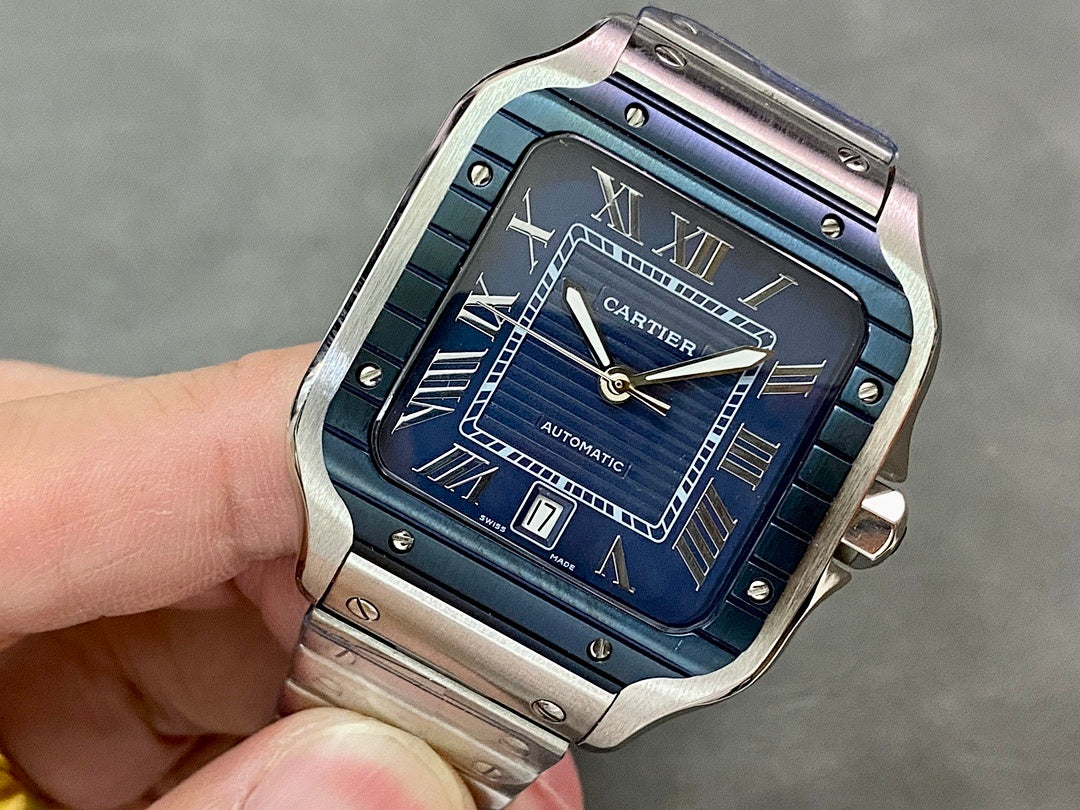 Cartier steel watch with blue Roman numeral dial and automatic markers