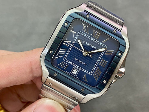 Cartier steel watch with blue Roman numeral dial and automatic markers