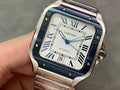 Cartier wristwatch with blue dial, Roman numerals, steel case, and link bracelet