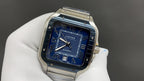 Stainless steel Cartier watch with blue dial, Roman numerals, and date window