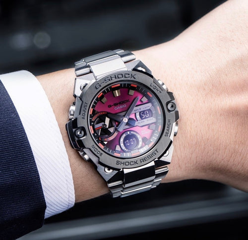 Casio G-Shock analog watch with metal bracelet, black case and pink dial