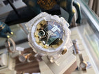 Digital wristwatch with translucent white case and gold-tone bezel, multi-dial face