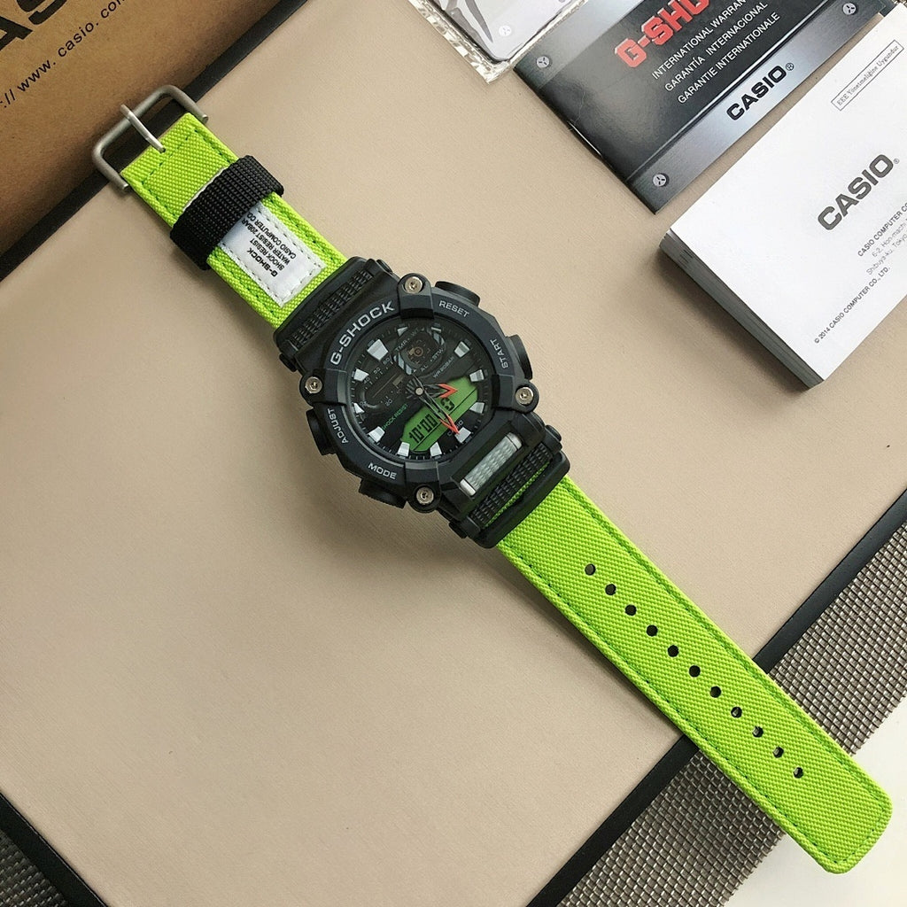 Casio G-Shock watch with black bezel and lime-green strap, dial facing up