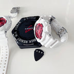 White resin wristwatch with red dial beside black G-Shock-style case and strap tag