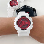 White resin wristwatch with red dial on a person’s wrist