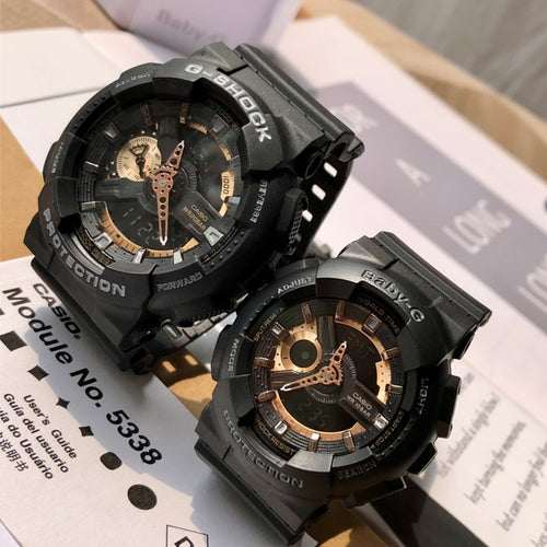 Casio G-Shock watch pair with black resin straps and analog dials, angled view