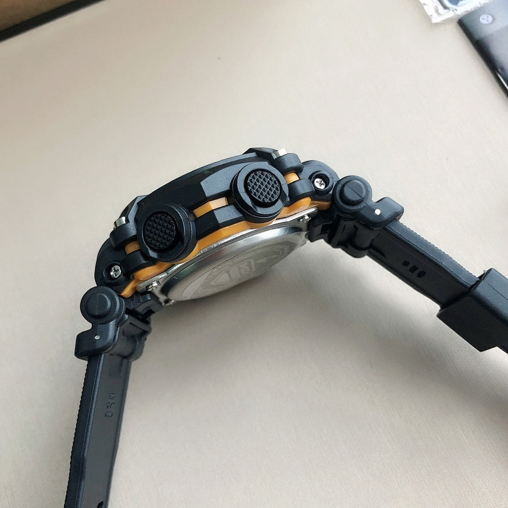 Black G-SHOCK wristwatch from side view with gold accents and textured strap