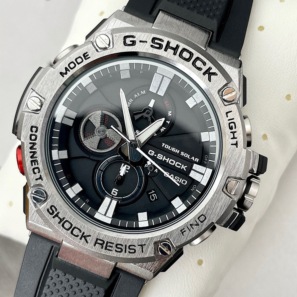 Casio G-Shock watch with black dial, silver bezel, and black silicone strap