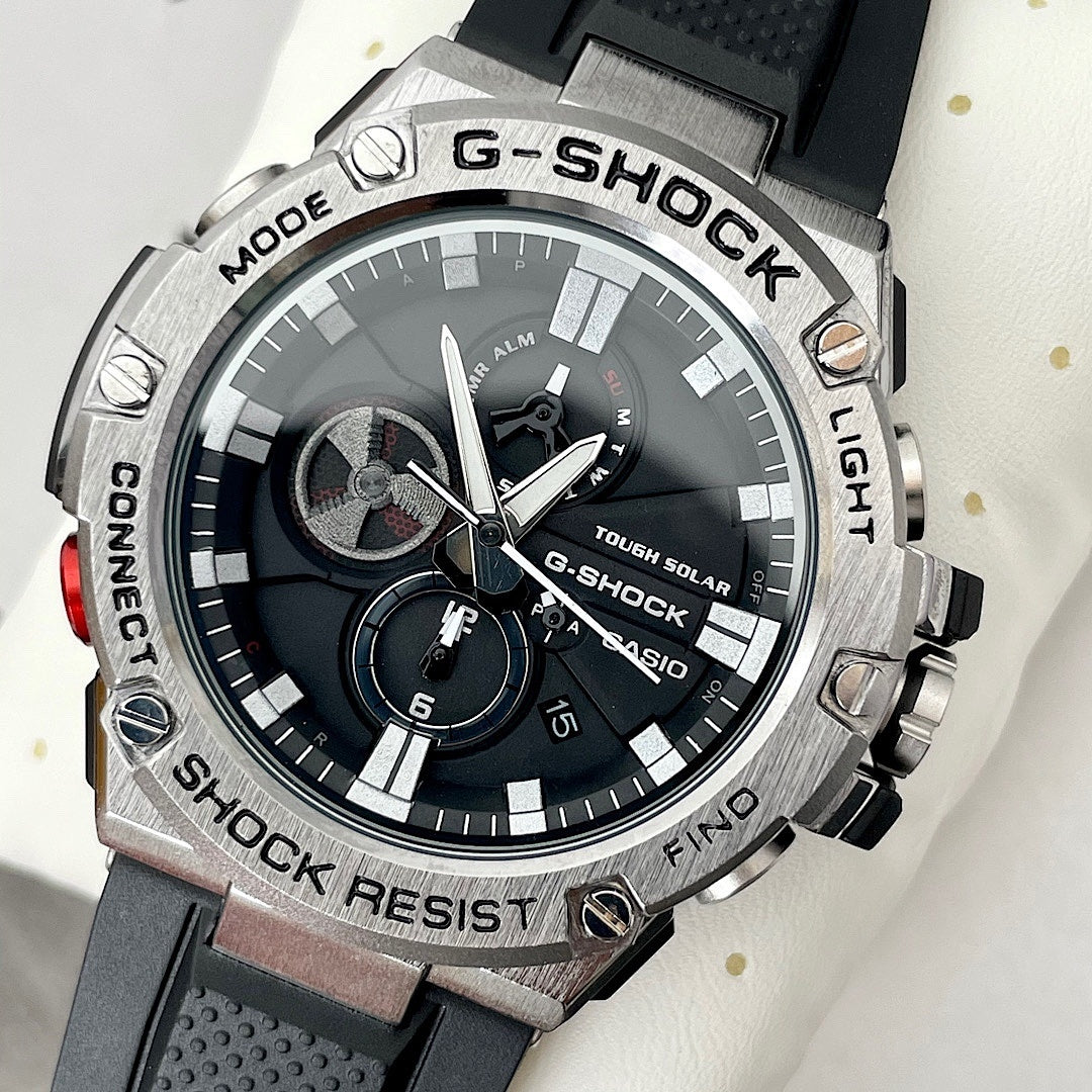 Casio G-Shock watch with black dial, silver bezel, and black silicone strap