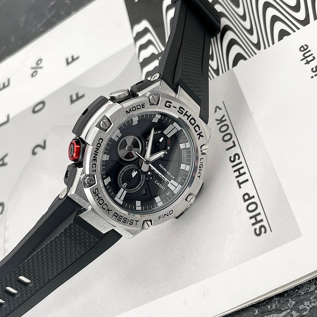 Casio G-Shock watch with black bezel and black dial, tilted on product packaging