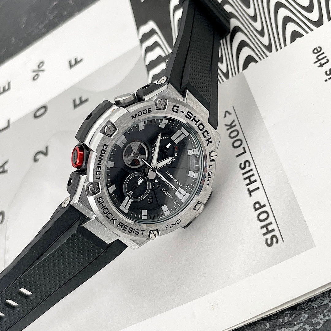 Casio G-Shock watch with black bezel and black dial, tilted on product packaging