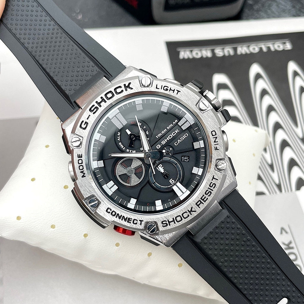 Casio G-Shock watch with black silicone strap and round black dial with silver markers