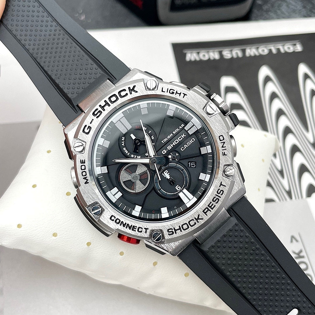 Casio G-Shock watch with black silicone strap and round black dial with silver markers