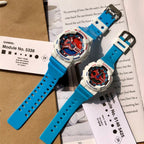 Casio G-Shock and Baby-G watches with blue straps and white cases beside documents