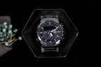 Casio G-Shock analog watch with dark bracelet and blue-accent dial, in case