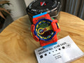 Casio watch with orange resin strap, round digital face, module label card