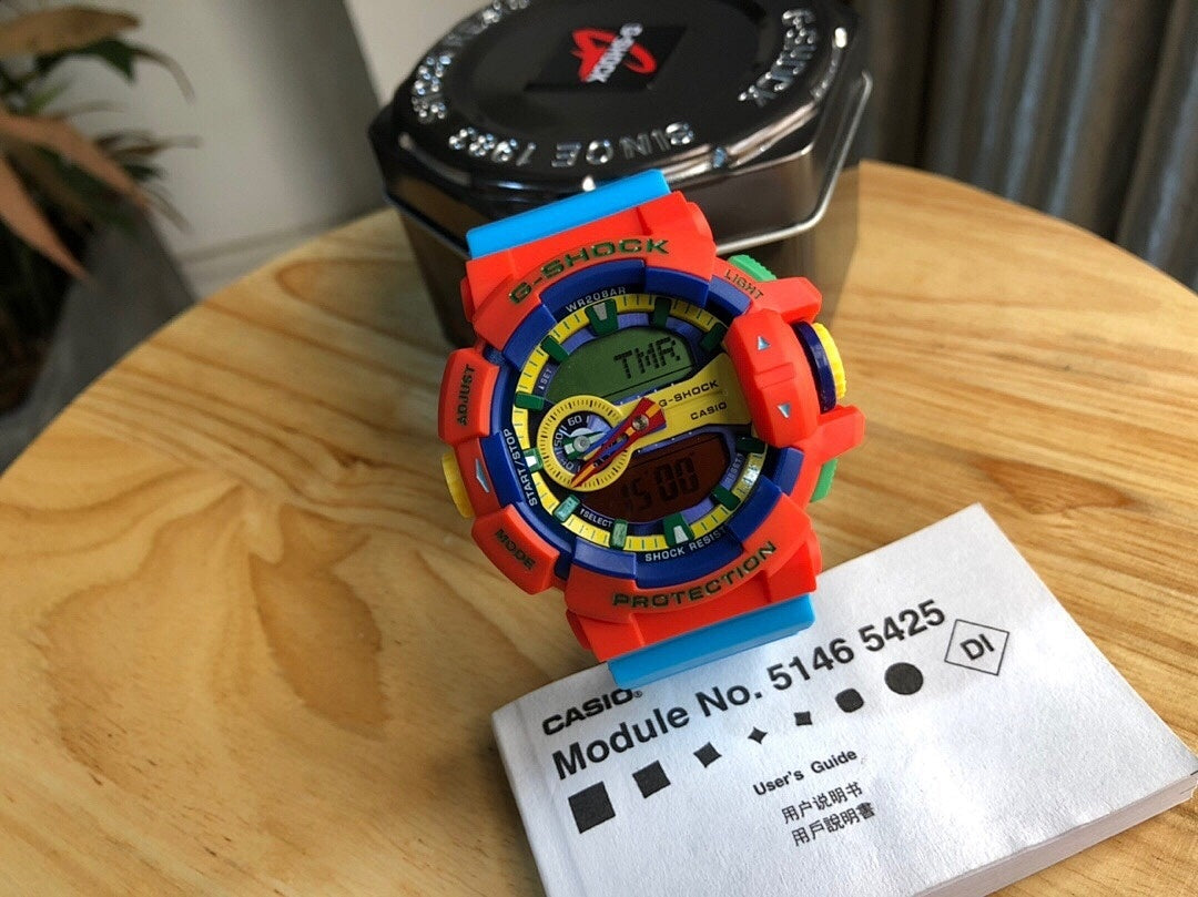 Casio watch with orange resin strap, round digital face, module label card