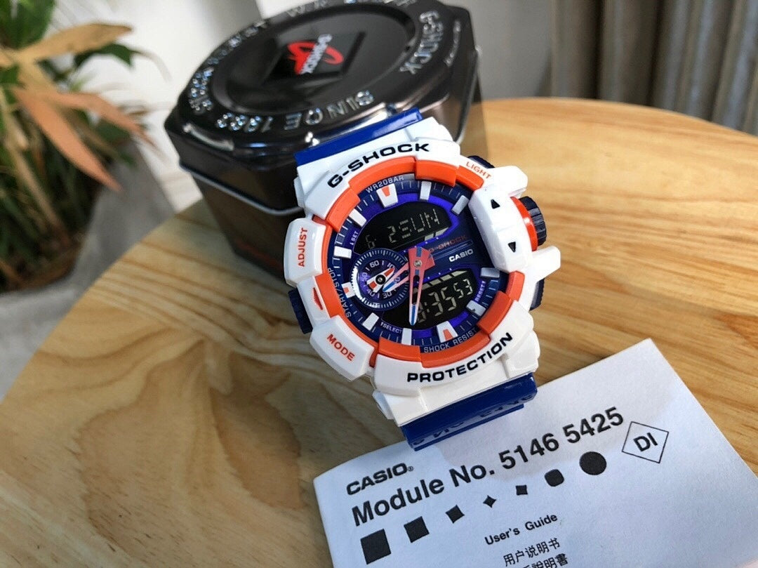 Casio watch with white resin strap, round digital face with blue and orange