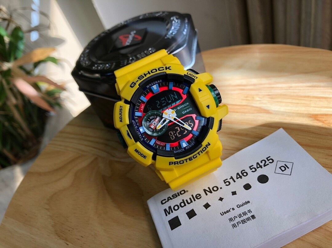 Casio watch with yellow resin strap, round digital face with red and green
