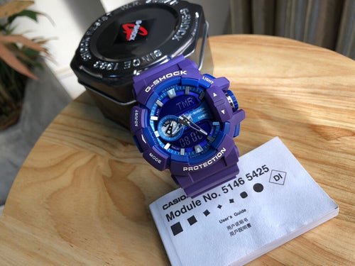 Casio watch with blue resin strap, round digital face, module label card