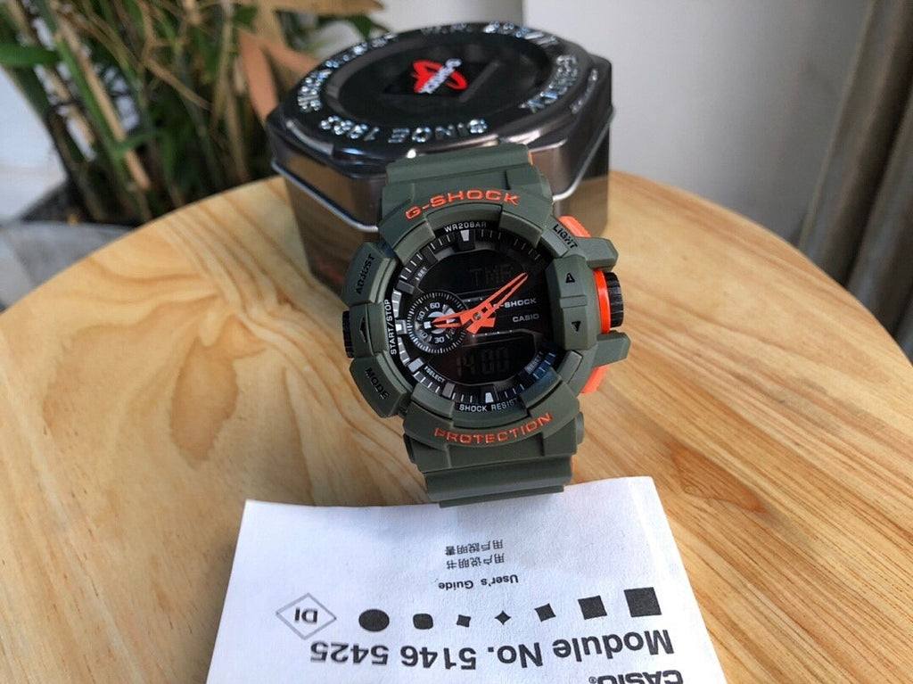 Casio watch with gray resin strap, round digital face with orange accents