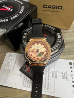 Casio G-Shock wristwatch with gold-tone bezel, black silicone strap, rose-toned digital face
