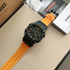 Casio G-Shock watch angled view, orange perforated strap and black dial with orange rings
