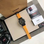Casio G-Shock watch on orange perforated strap, black dial with orange highlights