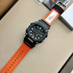 Casio G-Shock wristwatch with orange strap, black bezel, and dark textured wristband